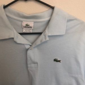 Light blue Lacoste polo.
